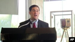 Arizona Gov. Doug Ducey talks about a new partnership between San Francisco-based Uber and the University of Arizona, Aug. 25, 2015, in Tucson. Ride-hailing service Uber partnered with the University of Arizona to help develop mapping technology and test self-driving cars.