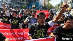 FILE - Reporters shout as they march demanding broader press freedom in Yangon, Myanmar, Jan. 7, 2014. A similar protest is planned for Thursday when two prominent journalists are to go on trial for alleged defamation.