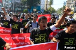 FILE - Reporters shout as they march demanding broader press freedom in Yangon, Myanmar, Jan. 7, 2014.