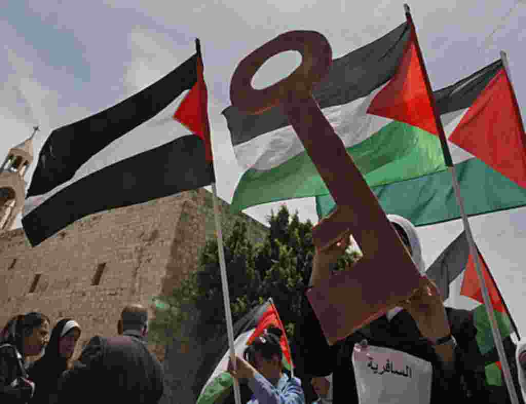Palestinians take part in a demonstration to mark the 63rd anniversary of "Nakba," in Manger Square outside the Church of Nativity in the West Bank city of Bethlehem, May 12, 2011