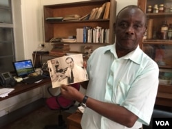 Louis Mukwaya, a mosquito researcher at the Uganda Virus Research Institute near Entebbe, displays a photograph of a Scottish medical entomologist. Alexander Haddow led the research team responsible for isolating the Zika virus in 1947. (J. Craig/VOA)
