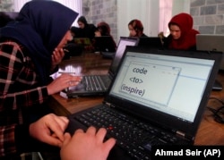 In this Sunday, Jan. 21, 2018 photo, Afghan coders practice at the Code to Inspire computer training center in Herat province, western Afghanistan.