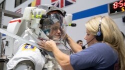 In this May 22, 2019, photo, 2017 NASA astronaut candidate Jessica Watkins is helped into a spacesuit prior to underwater spacewalk training at NASA Johnson Space Center’s Neutral Buoyancy Laboratory in Houston. Photo Credit: (NASA/David DeHoyos)