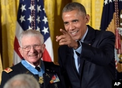 President Barack Obama points after presenting the Medal of Honor to retired Lt. Col. Charles Kettles of Michigan during a ceremony in the East Room of the White House in Washington, July 18, 2016.