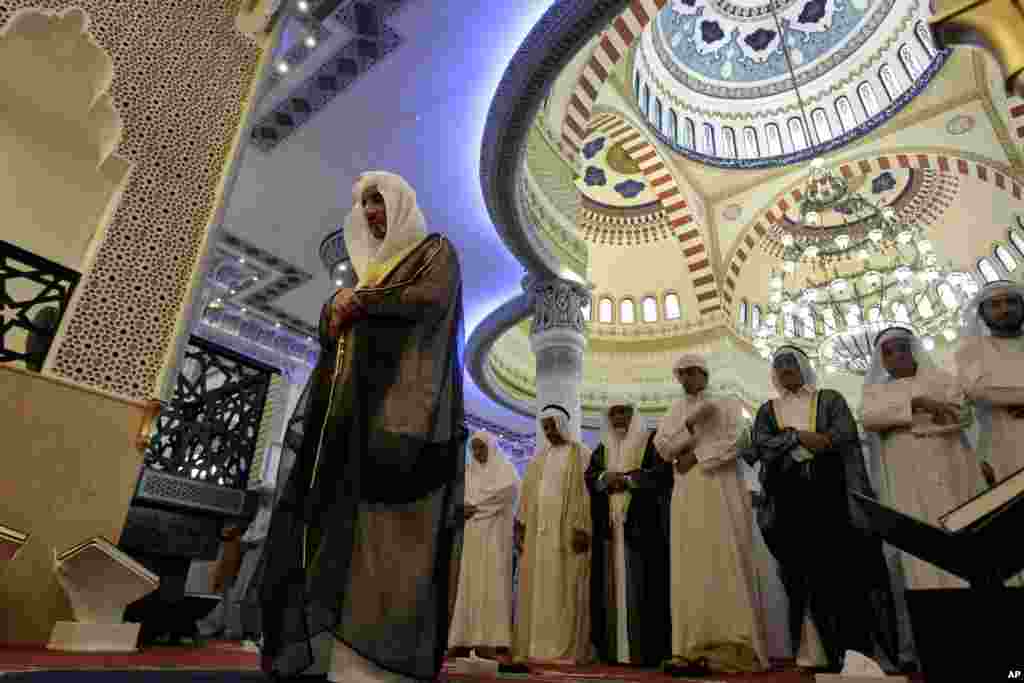 An Emirati Imam, left, leads Eid Al-Adha prayers at Farooq Omar Inb Al Khatab mosque in Dubai, United Arab Emirates, October 26, 2012. 