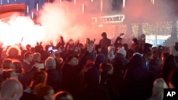 In this image taken from video, demonstrators rally against government-imposed COVID-19 restrictions, in Rotterdam, Netherlands, Nov. 19, 2021. 