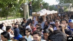 Anti-Syrian regime mourners chant slogans as they carry the body of soldier Khaled Shurbajy, who was shot by Syrian security forces in Dir el Zour last week after disobeying orders to fire on anti-Assad protesters, May 26, 2012