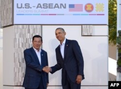 FILE - US President Barack Obama greets Cambodia's Prime Minister Hun Sen (L) upon arrival at Sunnylands estate for a meeting of the Association of Southeast Asian Nations (ASEAN) on February 15, 2016 in Rancho Mirage, California. (Photo by Mandel Ngan / AFP)