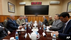 U.S. Secretary of Defense Chuck Hagel, left, meets with Afghanistan's Defense Minister Bismallah Khan Mohammadi, second right, at the ISAF (International Security Assistance Force) headquarters in Kabul, March 10, 2013.