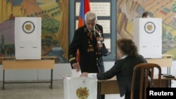 A man casts his ballot during the presidential election at a polling station in Yerevan, February 18, 2013.