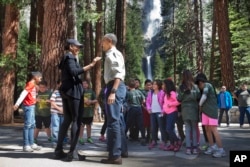 First lady Michelle Obama and President Barack Obama meet with children during the "Every Kid in a Park" event at Yosemite National Park, Calif., June 18, 2016. The Obama family traveled to Yosemite to celebrate the 100th anniversary of the creation of America's national park system.