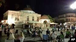 People sit at a square after an earthquake on the Greek island of Kos, July 21, 2017. A powerful earthquake struck Greek islands and Turkey's Aegean coast, damaging buildings and a port and killing at least two people.