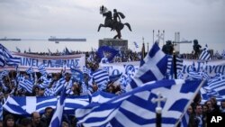 Greek protesters wave flags and banners during a rally against the use of the term "Macedonia" for the northern neighbouring country's name, at the northern Greek city of Thessaloniki on Sunday, Jan. 21, 2018. 
