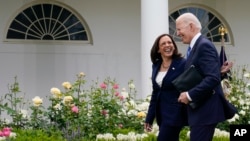 President Joe Biden and Vice President Kamala Harris, without masks, walk together after speaking on updated guidance on face mask mandates and COVID-19 response, in the Rose Garden of the White House, Thursday, May 13, 2021, in Washington. (AP Photo/Evan Vucci)