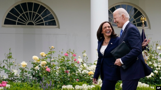 President Joe Biden and Vice President Kamala Harris, without masks, walk together after speaking on updated guidance on face mask mandates and COVID-19 response, in the Rose Garden of the White House, Thursday, May 13, 2021, in Washington. (AP Photo/Evan Vucci)