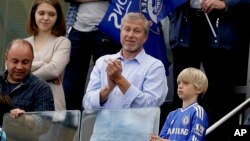 FILE - Chelsea's Russian billionaire owner Roman Abramovich applauds after Chelsea were presented with the Premier League trophy after English Premier League soccer match between Chelsea and Sunderland at Stamford Bridge stadium in London, May 24, 2015.