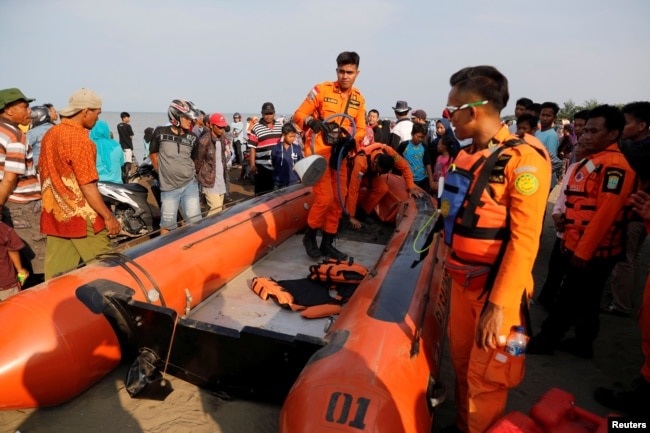 FILE - Rescue team members prepare the boat heading to the location of Lion Air, flight JT610, plane crash off the coast of Karawang regency, West Java province Indonesia, Oct. 29, 2018.