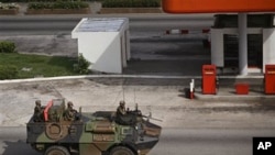 French troops drive past in a armored car in the city of Abidjan, Ivory Coast, March 31, 2011