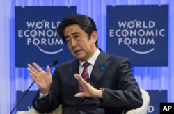 FILE - Japanese Prime Minister Shinzo Abe speaks at the World Economic Forum in Davos, Switzerland, Jan. 22, 2014.