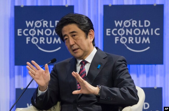 FILE - Japanese Prime Minister Shinzo Abe speaks at the World Economic Forum in Davos, Switzerland, Jan. 22, 2014.