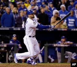 Kansas City Royals' Paulo Orlando flies out during the ninth inning of Game 1 of the Major League Baseball World Series against the New York Mets, Oct. 27, 2015, in Kansas City, Mo.