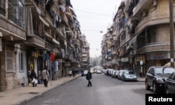 FILE - A man crosses a street in Aleppo, Syria, Dec. 12, 2009.