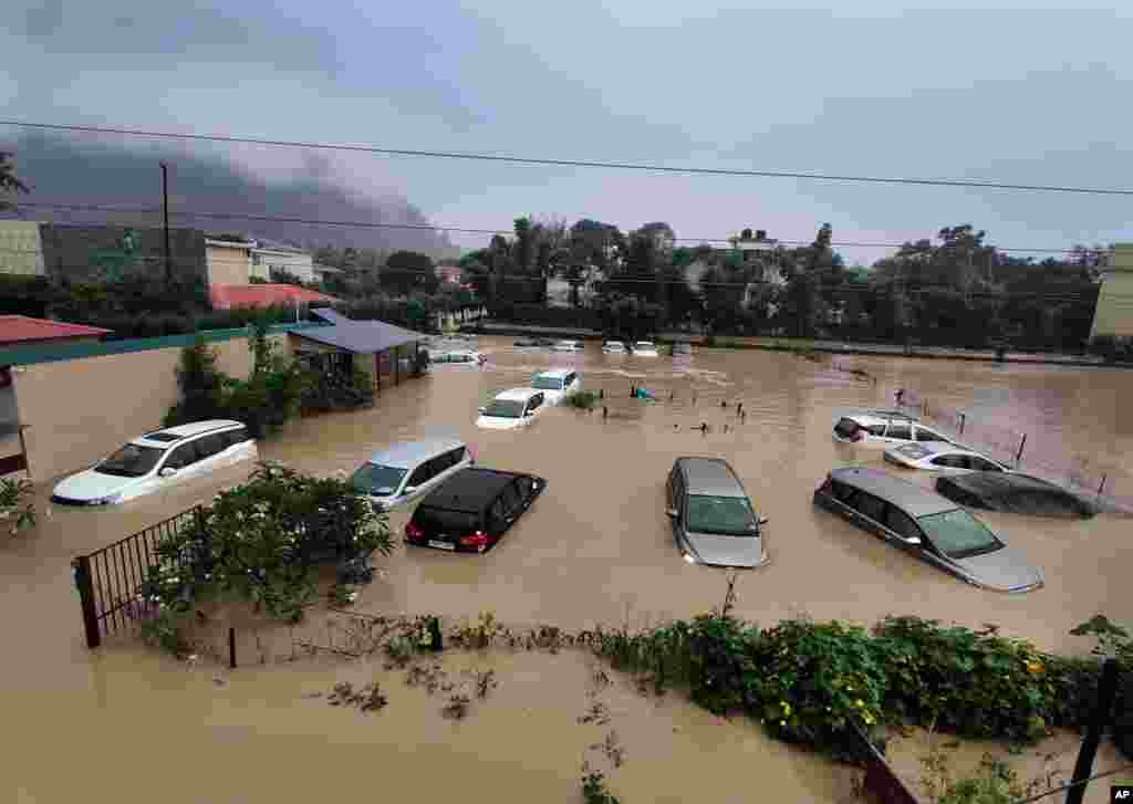 Cars are seen at a flooded hotel as extreme rainfall caused the Kosi River to overflow at the Jim Corbett National Park in Uttarakhand, India.