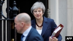 Britain's Prime Minister Theresa May leaves 10 Downing Street in London on November 14, 2018, to attend the weekly Prime Minister's Questions at the Houses of Parliament.