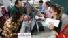 Cambodians sit for registering their names during a voter registration process of the National Election Committee (NEC) in Phnom Penh, Cambodia, Thursday, Sept. 1, 2016. NEC started its three-month-long voter registration in the day for the next general election scheduled for July 2018. (AP Photo/Heng Sinith)