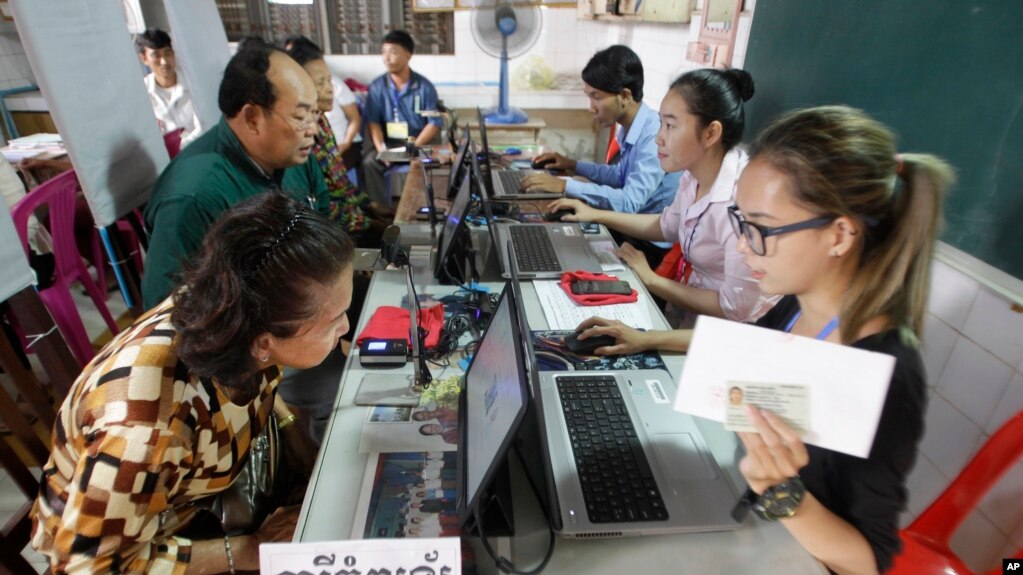 Locals sit for registering their names during a voter registration process of the National Election Committee (NEC) in Phnom Penh, Cambodia, Thursday, Sept. 1, 2016. 