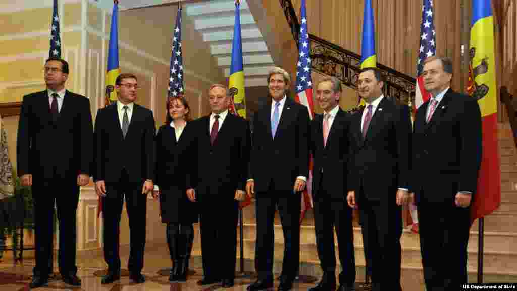 U.S. Secretary of State Kerry poses for a photo with officials from Moldova after their meeting in Chisinau, Moldova, on December 4, 2013.