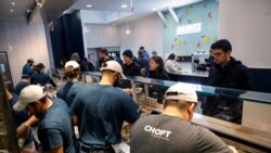 Workers prepare orders in the kitchen at a Chopt Creative Salad Co., location in midtown Manhattan, in New York City, U.S., November 12, 2019.