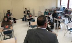 Secretary of Education Miguel Cardona talks to students at White Plains High School, Thursday, April 22, 2021, in White Plains, N.Y. (AP Photo/Mark Lennihan)