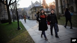 Yale University sophomore Yupei Guo, left, walks with friend Joseph Lachman on the school's campus in New Haven, Conn., in 2014