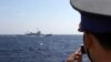 A May 15, 2014 photo shows an officer on board Vietnam Coast Guard 4033 vessel filming China Coast Guard 3411 vessel sailing in waters claimed by both countries in the South China Sea.