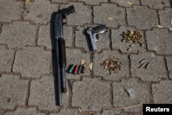 Seized weapons from suspected members of the 18th street gang are presented to the media after they were arrested by the police under the charges of homicide and terrorism, in Soyapango, El Salvador, March 31, 2016.