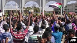 Sudanese protesters shout slogans in front of the military headquarters in the capital Khartoum, April 6, 2019. 