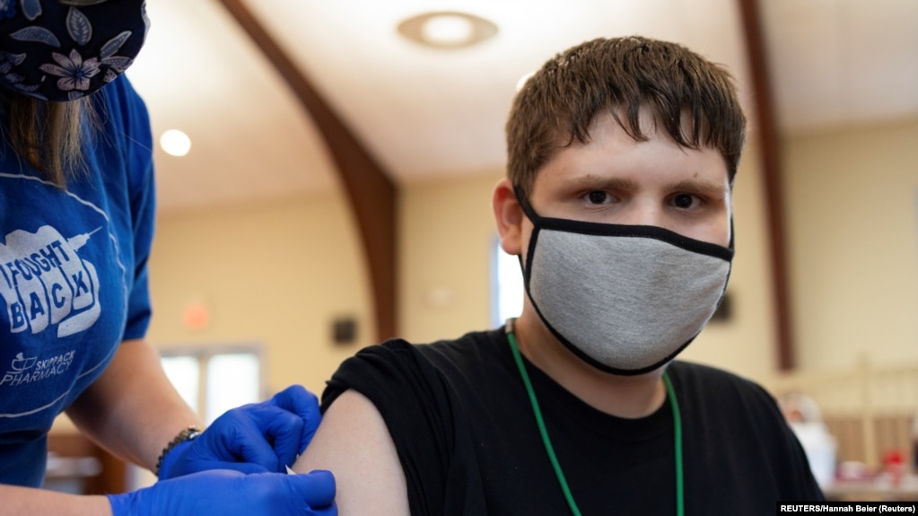 USA, Pennsylvania, Thomas Macconnell, 16, who is on the autism spectrum, is given a band-aid after receiving a coronavirus disease (COVID-19) vaccine 