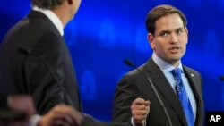 Marco Rubio, right, and Jeb Bush, argue a point during the CNBC Republican presidential debate at the University of Colorado, Wednesday, Oct. 28, 2015.