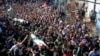 Palestinian mourners carry the bodies of two of the seven Hamas militants who were killed in an Israeli raid late Sunday, during their funerals in Khan Younis, southern Gaza Strip, Nov. 12, 2018.