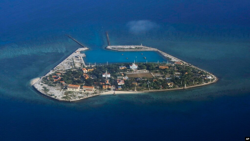 FILE - The Vietnamese-claimed Southwest Cay island in the Spratly island group is seen from a Philippine Air Force C-130 transport plane during the visit to the Philippine-claimed Thitu Island by Defense Secretary Delfin Lorenzana, Armed Forces Chief Gen.