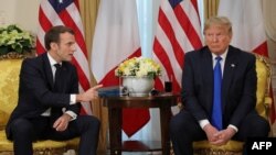US President Donald Trump (R) France's President Emmanuel Macron react as they talk during their meeting at Winfield House, London on December 3, 2019.