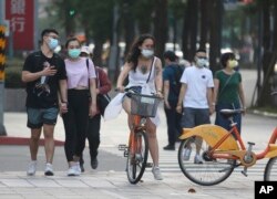 People wear face masks to protect against the spread of the coronavirus after the COVID-19 alert raise to level 3 in Taipei, Taiwan, Saturday, May 15, 2021.