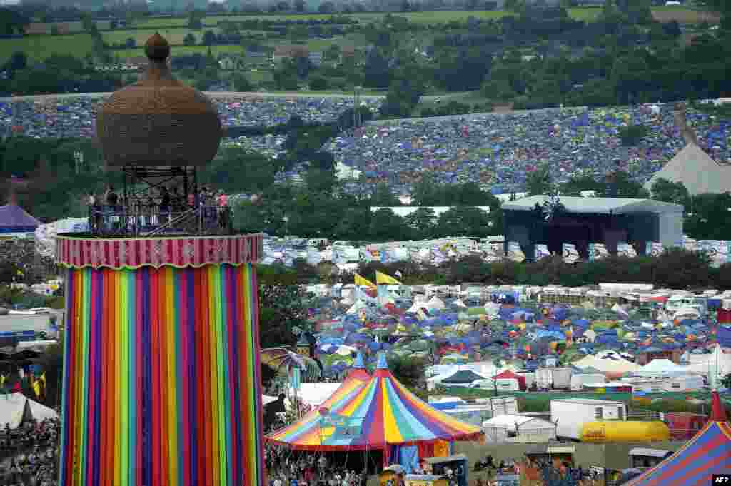 A general view shows the Ribbon Tower, tents and revelers on the second day of the Glastonbury Festival of Music and Performing Arts on Worthy Farm near the village of Pilton in Somerset, South West England, June 22, 2016.