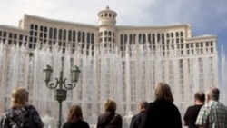Visitors watch the dancing fountain at the Bellagio Hotel and Casino in Las Vegas, Nevada.