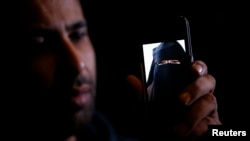 Foad, the brother of 15 year-old Nora who left for Syria nine months ago, shows her portrait on his cell phone, Oct. 6, 2014. (REUTERS/Christian Hartmann)