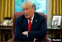 U.S. President Donald Trump answers a question during an interview with Reuters in the Oval Office of the White House in Washington, Aug. 20, 2018.