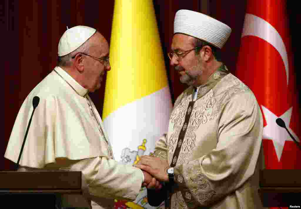 Pope Francis shakes hands with Mehmet Gormez, head of Turkey's Religious Affairs Directorate, in Ankara, Nov. 28, 2014.