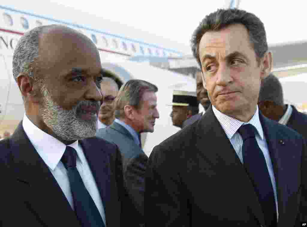 France's President Nicolas Sarkozy, right is welcomed by Haitian President Rene Preval upon his arrival in Port au Prince Wednesday, Feb. 17, 2010. Sarkozy made the first visit ever by a French president to Haiti, once his nation's richest colony _ offeri
