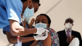 A woman receives the AstraZeneca/Oxford vaccine under the COVAX program against COVID-19 at the Eka Kotebe General Hospital in Addis Ababa, Ethiopia March 13, 2021. REUTERS/Tiksa Negeri
